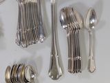 a lot of silver spoons and forks on the table