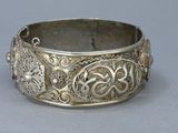 an image of a silver bracelet with intricate designs on it