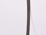 a small metal object with a long handle on a white surface