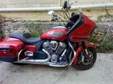 a red motorcycle that is parked in front of a building