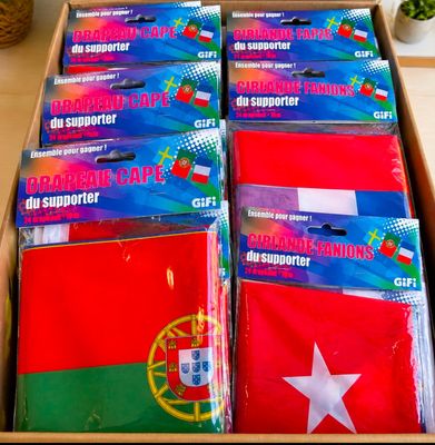 boxes of various flags are stacked on top of each other on a table