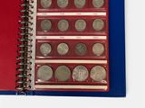 a red notebook with a bunch of coins in it
