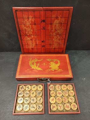 an old chinese game set with two trays and a game board