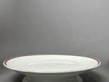 a white plate with gold trim and a white bowl with a gold rim