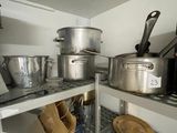 many pots and pans on the shelves in the kitchen