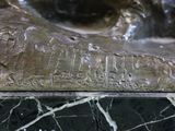 a close up of a statue of a cat on a marble surface