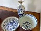 two bowls and a plate sitting on a wooden table