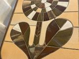 a picture of a stained glass table with a flower on it