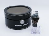 the watch is next to a black box with a watch in it