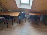 a room with several chairs and a table in it