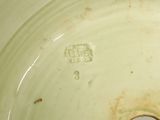 a close up of a white bowl with a hole in it