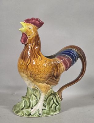 a ceramic rooster that is sitting on a table