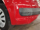a close up of a red car that is in a garage