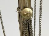 a close up of a metal pole with chains attached to it