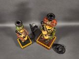 pair of ceramic figurines of a man and a woman on a pedestal