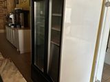 a refrigerator in the middle of a kitchen with a marble counter top