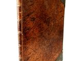 an old book with a brown cover on a white background
