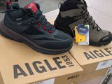 pair of men ' s hiking boots sitting on top of a cardboard box