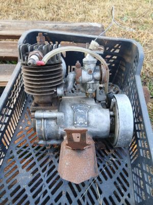 a small engine sitting in a basket on the ground