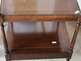 a wooden table with a glass shelf on it