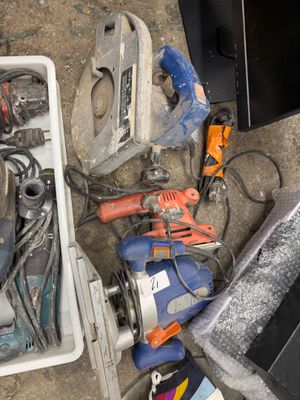 many tools that are sitting on the floor next to a laptop