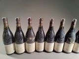 several bottles of wine are lined up in a row