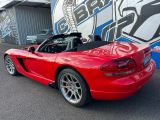 a red sports car that is parked in front of a building
