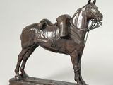 statue of a horse and rider on a wooden base on a white background