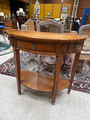a wooden table with a shelf on it in a room