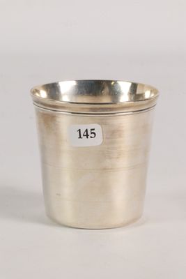 an antique silver cup with a label on the side of it