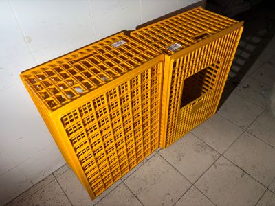 a yellow crate sitting on the floor next to a toilet