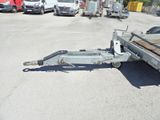 an image of a flatbed trailer in a parking lot