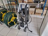 several hoses are lined up on the floor in a room