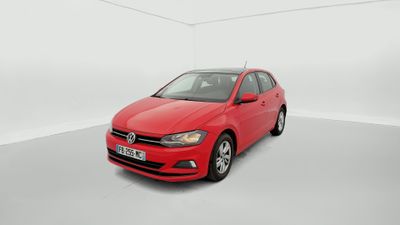 a red volkswagen polo parked in a white room