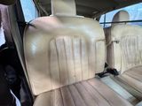 beige leather seats in the back of a car in a parking lot