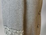 a close up of a mannequin wearing a gray jacket with a brown belt