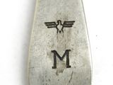 a silver spoon with a bird on it on a white surface