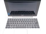 a white laptop with a black keyboard sitting on a table