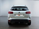 the rear end of a white citrole parked in a room