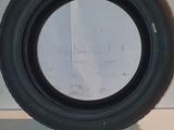 tires are lined up on a white surface in a room