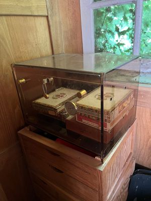 a glass display case with cigars on top of it