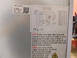 a metal refrigerator with a sticker on it in a room