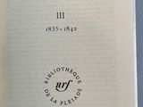 an open book with a black and white image of a person ' s hand holding it