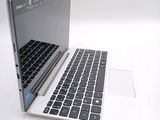 a white laptop with a black keyboard on a white surface