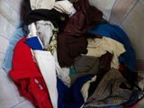 a pile of clothes in a basket on the floor