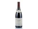 a bottle of wine that is sitting on a white surface