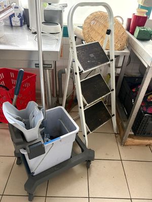 a mop and bucket in the corner of a room