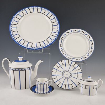 a blue and white plate and cups and a teapot