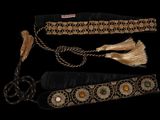 three different types of belts with tassels on a black background