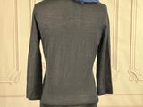 grey jacket with a blue scarf on a mannequin base